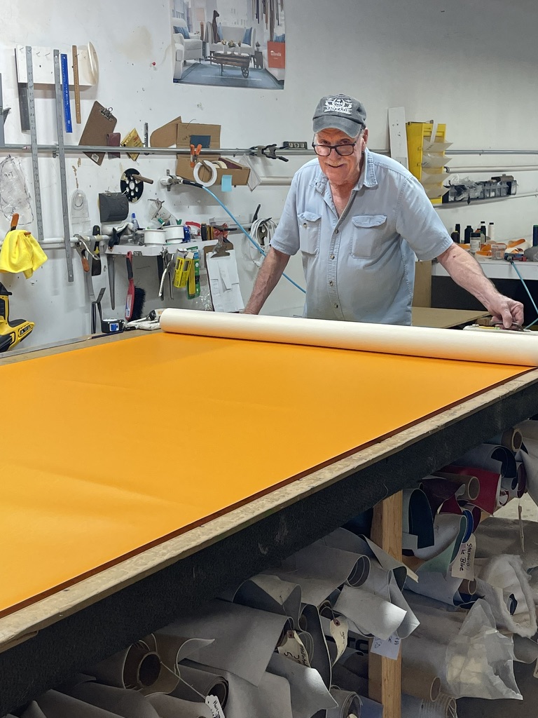 A team member preparing material in the workshop